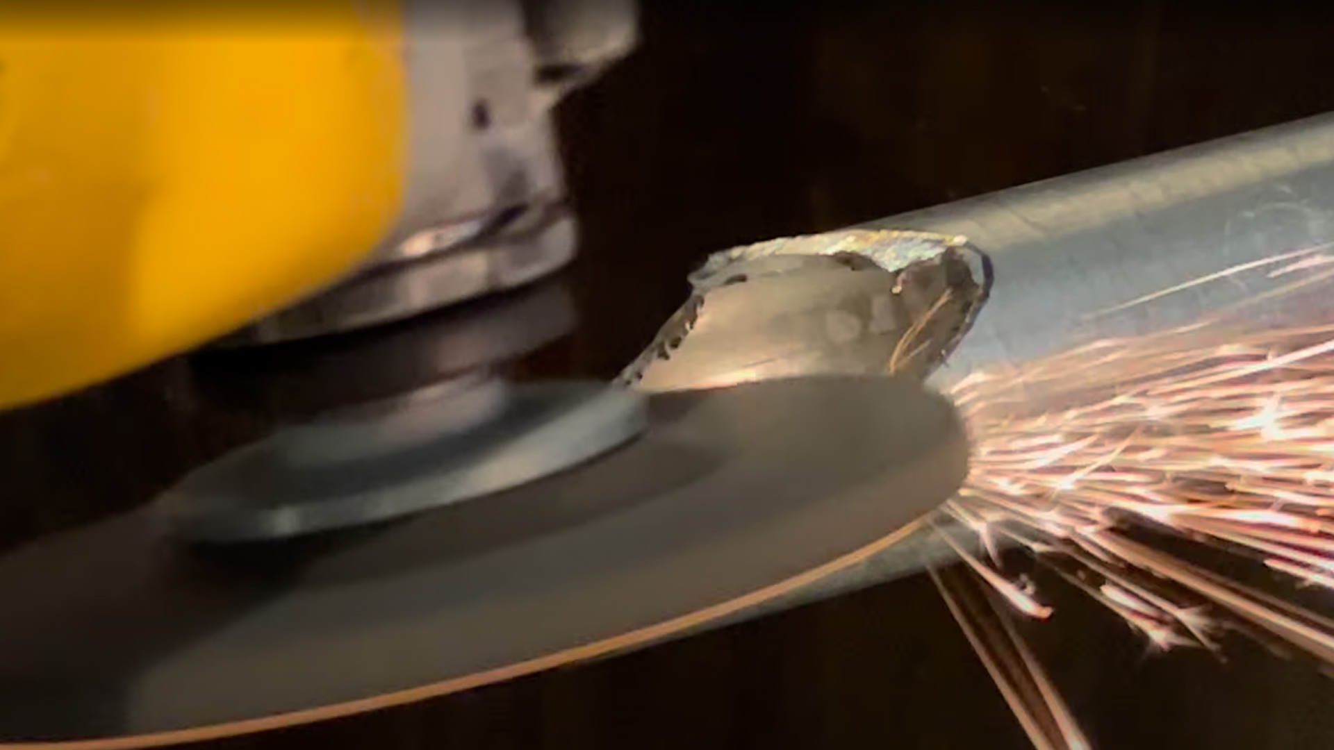 An action shot of grinding a pipe saddle joint.